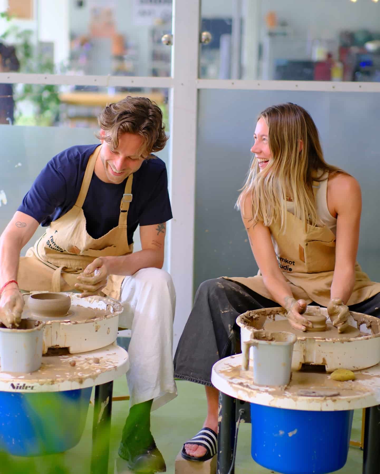 Students learning wheel pottery in a Dharamkot Studio workshop.