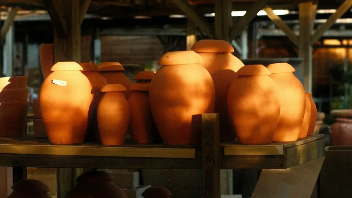 Raku or soda kiln pottery firing process in a studio setting.