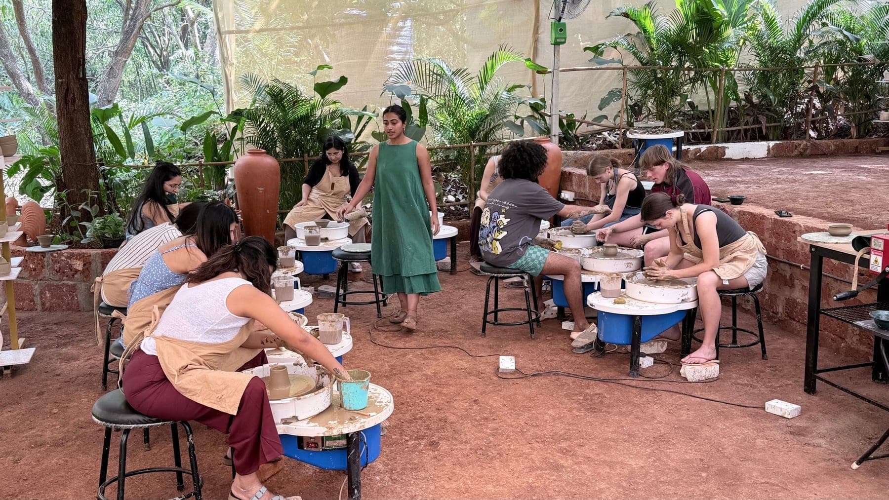People making pottery together during a Dharamkot Studio retreat in Himachal Pradesh.