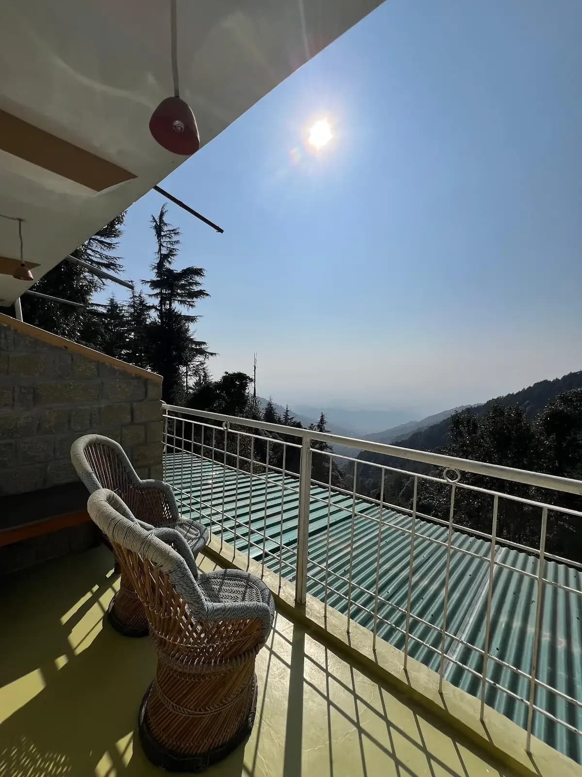 Mountain view balcony seating at the Himachal pottery retreat accommodation.